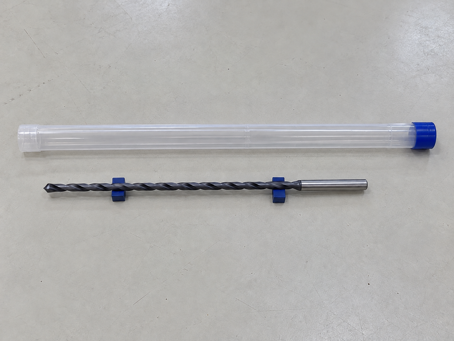 A long deep-hole drill and a correctly sized protective tube